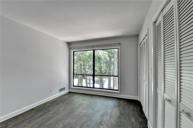 945 Tiber Cir, Alpharetta, GA 30022 - unfurnished bedroom with baseboards and dark wood finished floors