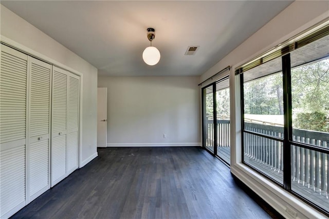 945 Tiber Cir, Alpharetta, GA 30022 - unfurnished bedroom with multiple windows, dark wood-type flooring, baseboards, and access to exterior