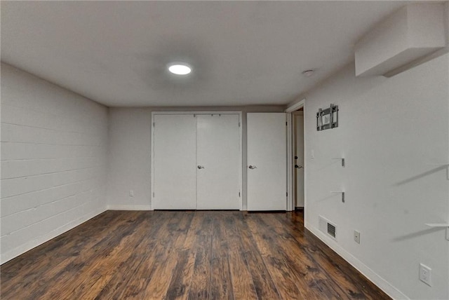 945 Tiber Cir, Alpharetta, GA 30022 - unfurnished bedroom with baseboards, dark wood finished floors, and a closet