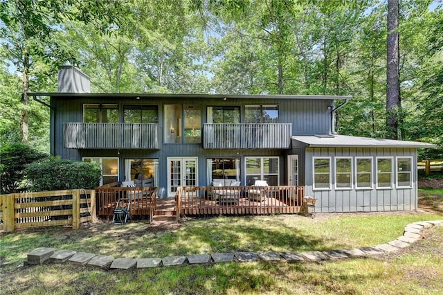 945 Tiber Cir, Alpharetta, GA 30022 - back of house with a chimney, a balcony, and a wooden deck