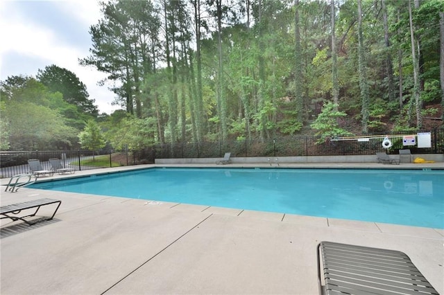 945 Tiber Cir, Alpharetta, GA 30022 - community pool with a patio area and a forest view