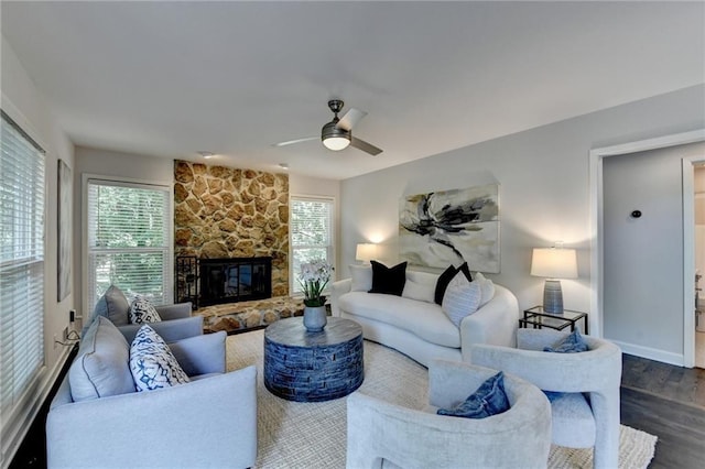 945 Tiber Cir, Alpharetta, GA 30022 - living area featuring dark wood finished floors, ceiling fan, a stone fireplace, and baseboards