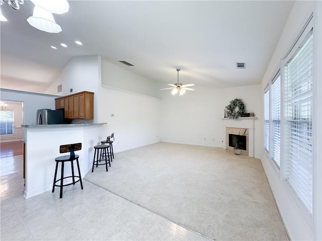 2642 Colleen Ln, Dacula, GA 30019 - living room with vaulted ceiling, light colored carpet, a fireplace, ceiling fan, and recessed lighting
