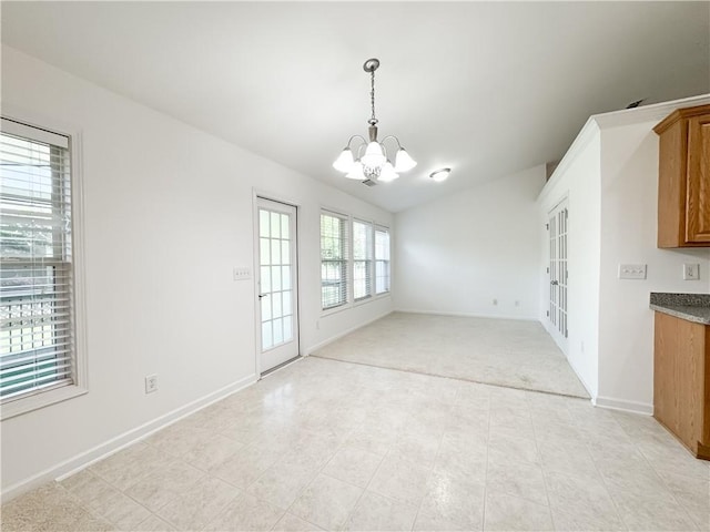 2642 Colleen Ln, Dacula, GA 30019 - unfurnished dining area with a chandelier, lofted ceiling, baseboards, and light carpet