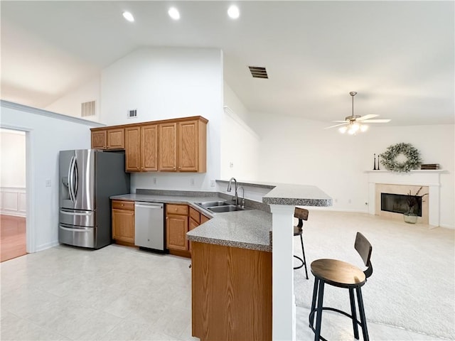 2642 Colleen Ln, Dacula, GA 30019 - kitchen with stainless steel appliances, a sink, a peninsula, a breakfast bar, and a ceiling fan