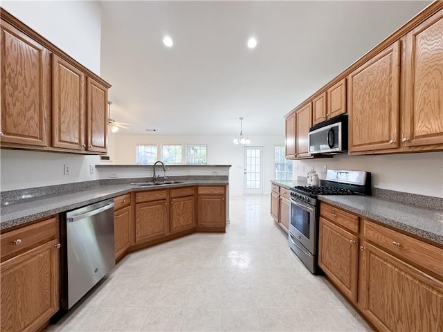 2642 Colleen Ln, Dacula, GA 30019 - kitchen featuring stainless steel appliances, a sink, dark countertops, a peninsula, and recessed lighting
