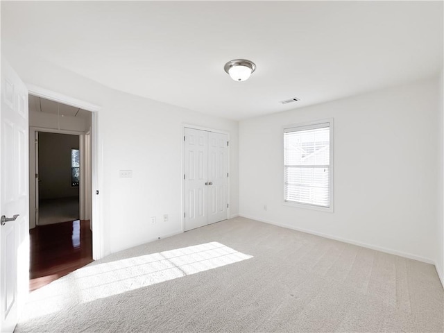 2642 Colleen Ln, Dacula, GA 30019 - unfurnished bedroom with attic access, light carpet, baseboards, and a closet