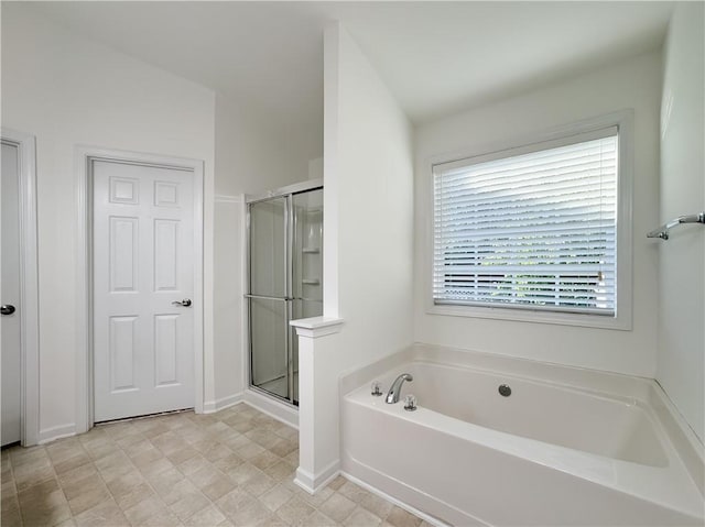 2642 Colleen Ln, Dacula, GA 30019 - full bathroom with a bath, a stall shower, and baseboards