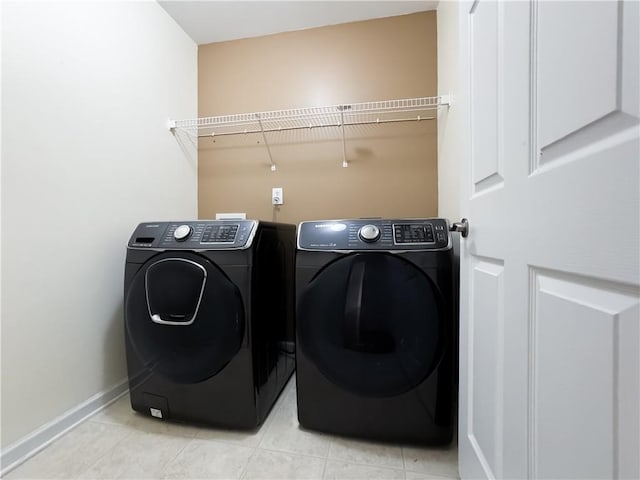 2642 Colleen Ln, Dacula, GA 30019 - laundry room featuring separate washer and dryer, light tile patterned flooring, and baseboards