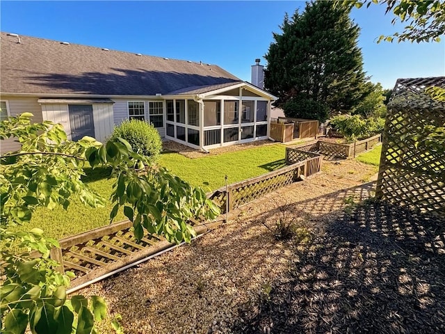 2642 Colleen Ln, Dacula, GA 30019 - view of grassy yard featuring a vegetable garden and a sunroom