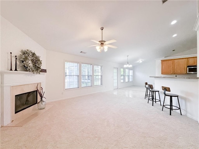 2642 Colleen Ln, Dacula, GA 30019 - living room with a fireplace, light carpet, ceiling fan, lofted ceiling, and a chandelier