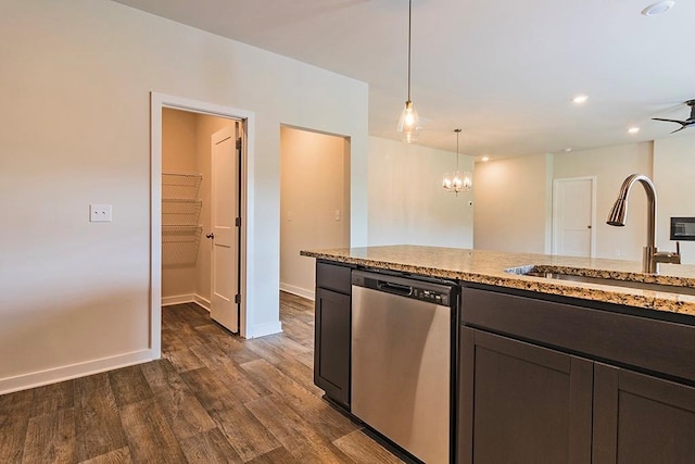 kitchen featuring a sink, dark wood-style floors, light stone counters, and stainless steel dishwasher