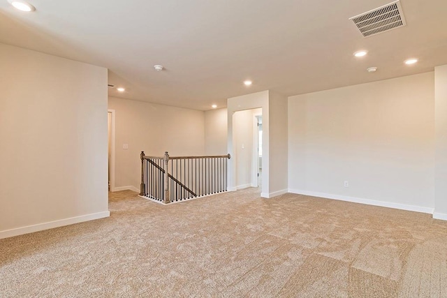 empty room featuring recessed lighting, visible vents, and baseboards