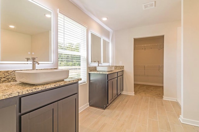 bathroom with two vanities, a sink, visible vents, and recessed lighting