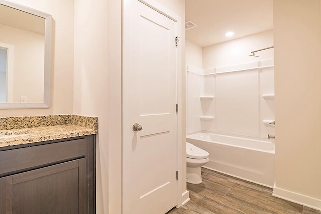 full bathroom featuring toilet, wood finished floors, visible vents, vanity, and shower / bathing tub combination