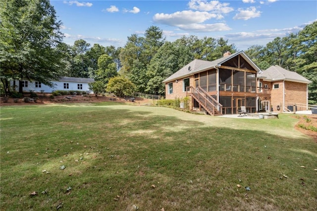 view of yard featuring a sunroom and a patio area