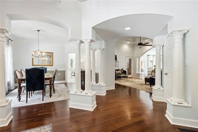 interior space with crown molding, dark hardwood / wood-style floors, and ornate columns