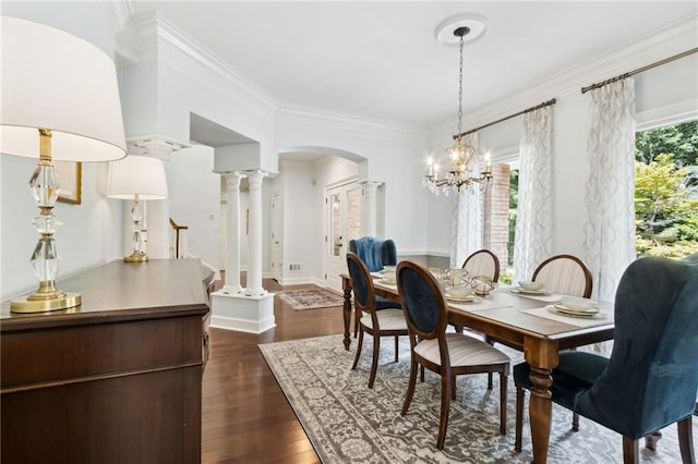 dining space with a chandelier, ornamental molding, dark hardwood / wood-style flooring, and ornate columns