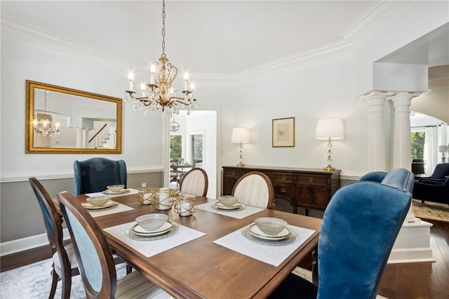 dining area with decorative columns, dark hardwood / wood-style floors, an inviting chandelier, and crown molding