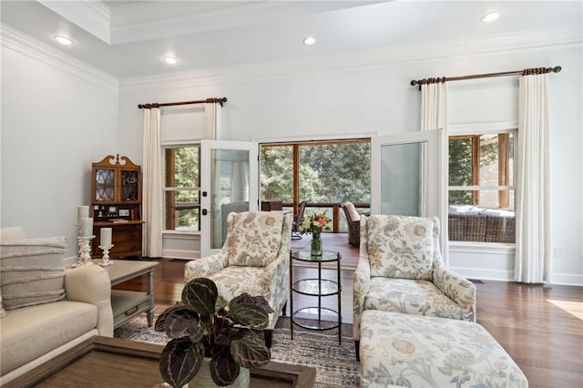 living area with dark hardwood / wood-style flooring and ornamental molding