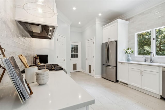 kitchen featuring custom range hood, ornamental molding, stainless steel refrigerator, white cabinetry, and light tile patterned flooring