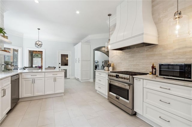 kitchen with premium range hood, stainless steel appliances, white cabinetry, and pendant lighting