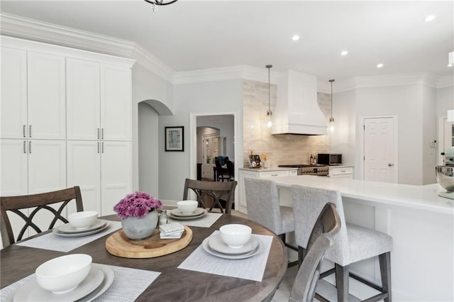 dining space with crown molding