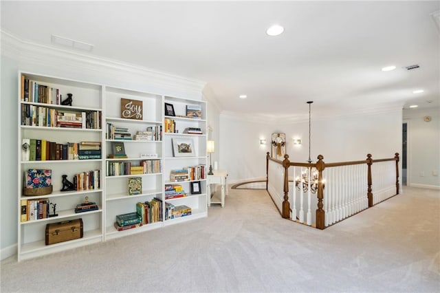 living area featuring crown molding, light carpet, and a chandelier