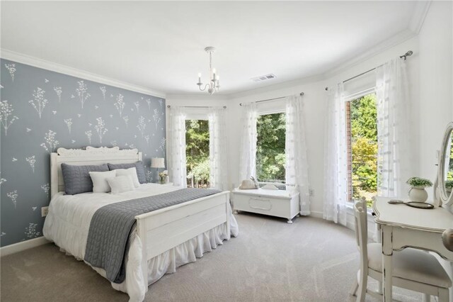 carpeted bedroom featuring ornamental molding and a notable chandelier