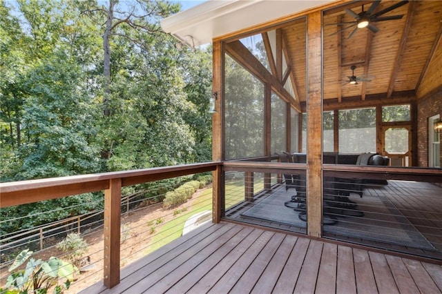 wooden deck featuring ceiling fan and a sunroom