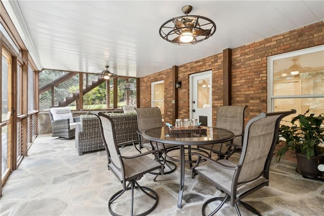 sunroom / solarium featuring ceiling fan