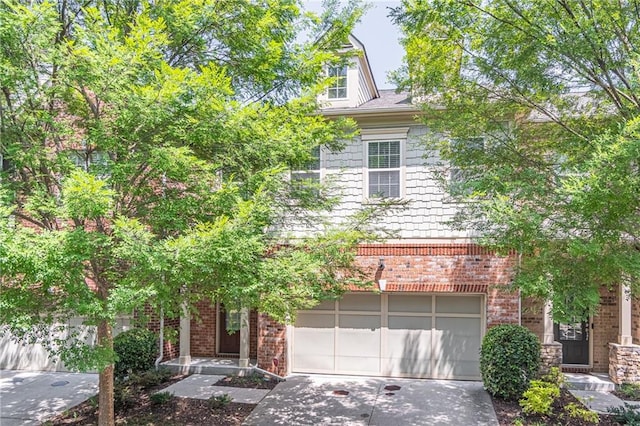 view of property hidden behind natural elements featuring a garage