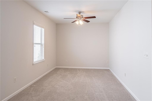 unfurnished room with ceiling fan and light carpet