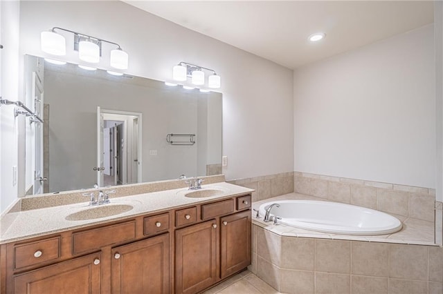 bathroom with vanity, tiled bath, and tile patterned floors