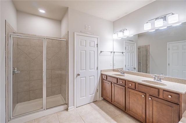 bathroom with tile patterned flooring, vanity, and an enclosed shower