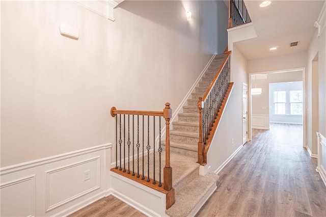 stairs featuring hardwood / wood-style flooring