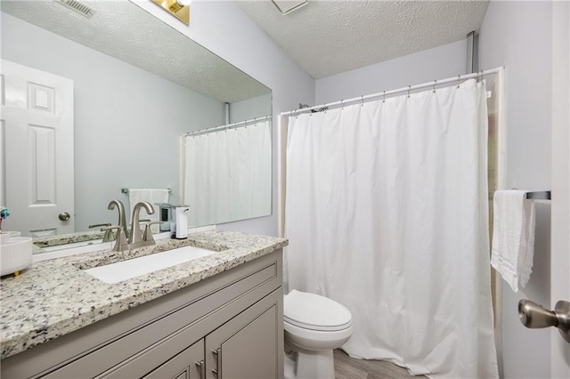 2507 Albion Farm Way, Duluth, GA 30097 - full bathroom featuring toilet, vanity, a textured ceiling, wood finished floors, and a shower with shower curtain