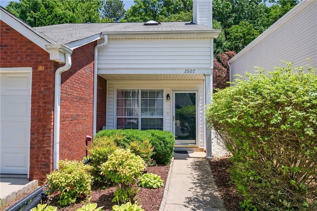 2507 Albion Farm Way, Duluth, GA 30097 - property entrance featuring a chimney, brick siding, and a garage