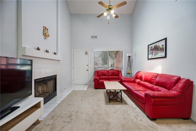 2507 Albion Farm Way, Duluth, GA 30097 - living room with a high ceiling, a ceiling fan, a tiled fireplace, tile patterned floors, and carpet