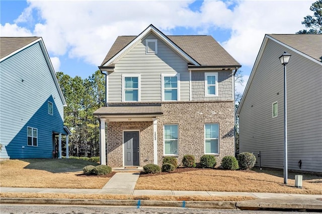 view of front of home featuring brick siding