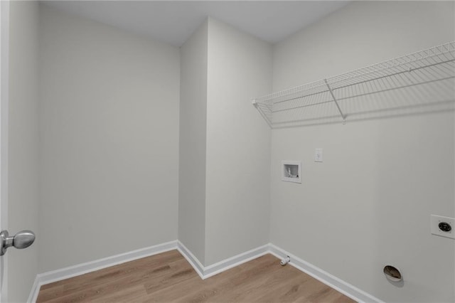 washroom with light wood-type flooring, laundry area, hookup for a washing machine, and hookup for an electric dryer