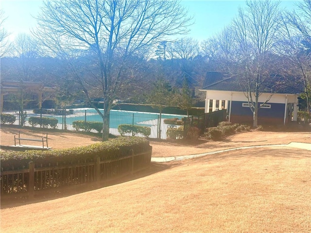 exterior space featuring a fenced in pool and fence