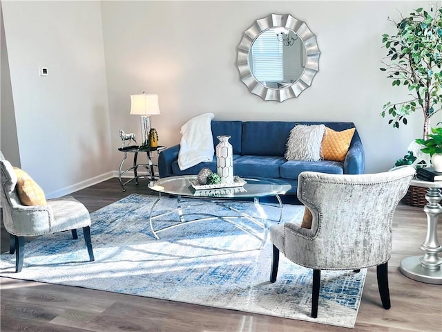 living area with wood finished floors and baseboards