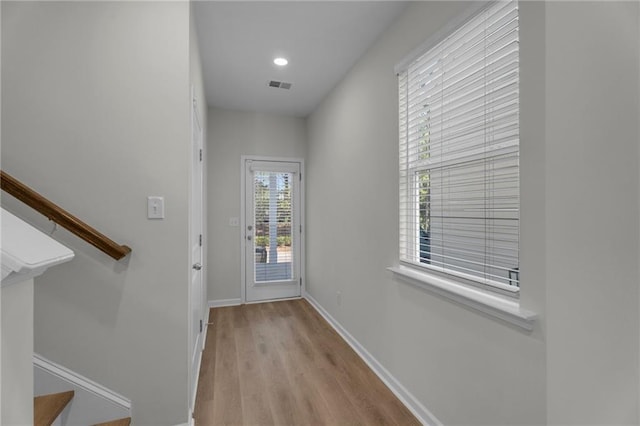 doorway with baseboards, visible vents, stairway, wood finished floors, and recessed lighting