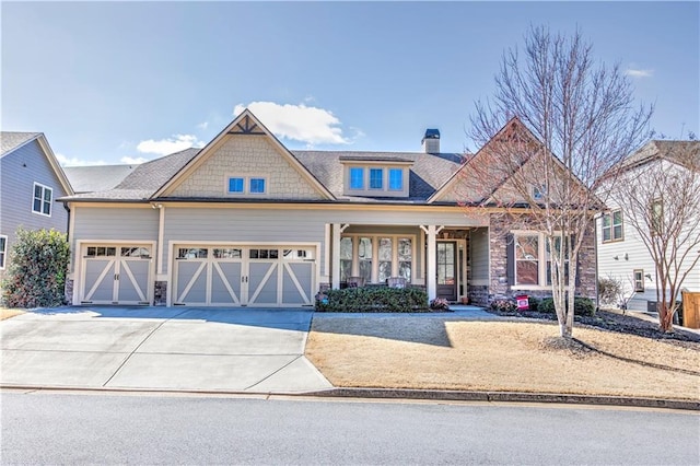 craftsman house with a garage and concrete driveway