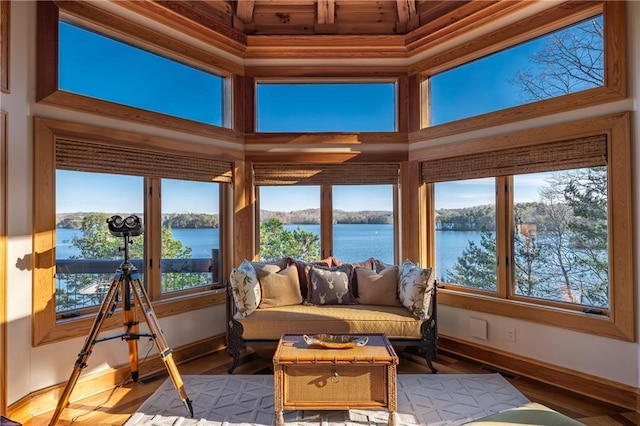 sunroom / solarium featuring a water view