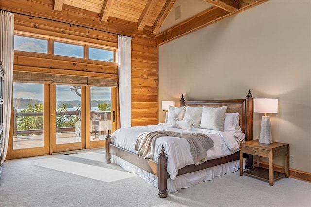 bedroom with carpet flooring, wood ceiling, beam ceiling, wood walls, and access to outside