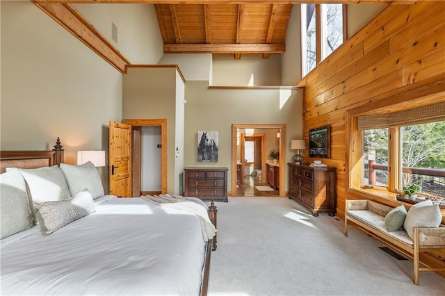 carpeted bedroom with high vaulted ceiling, wood walls, visible vents, beamed ceiling, and wooden ceiling