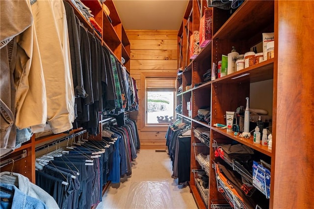 walk in closet with light colored carpet