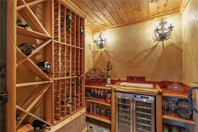 wine room with wooden ceiling, wine cooler, and a textured wall